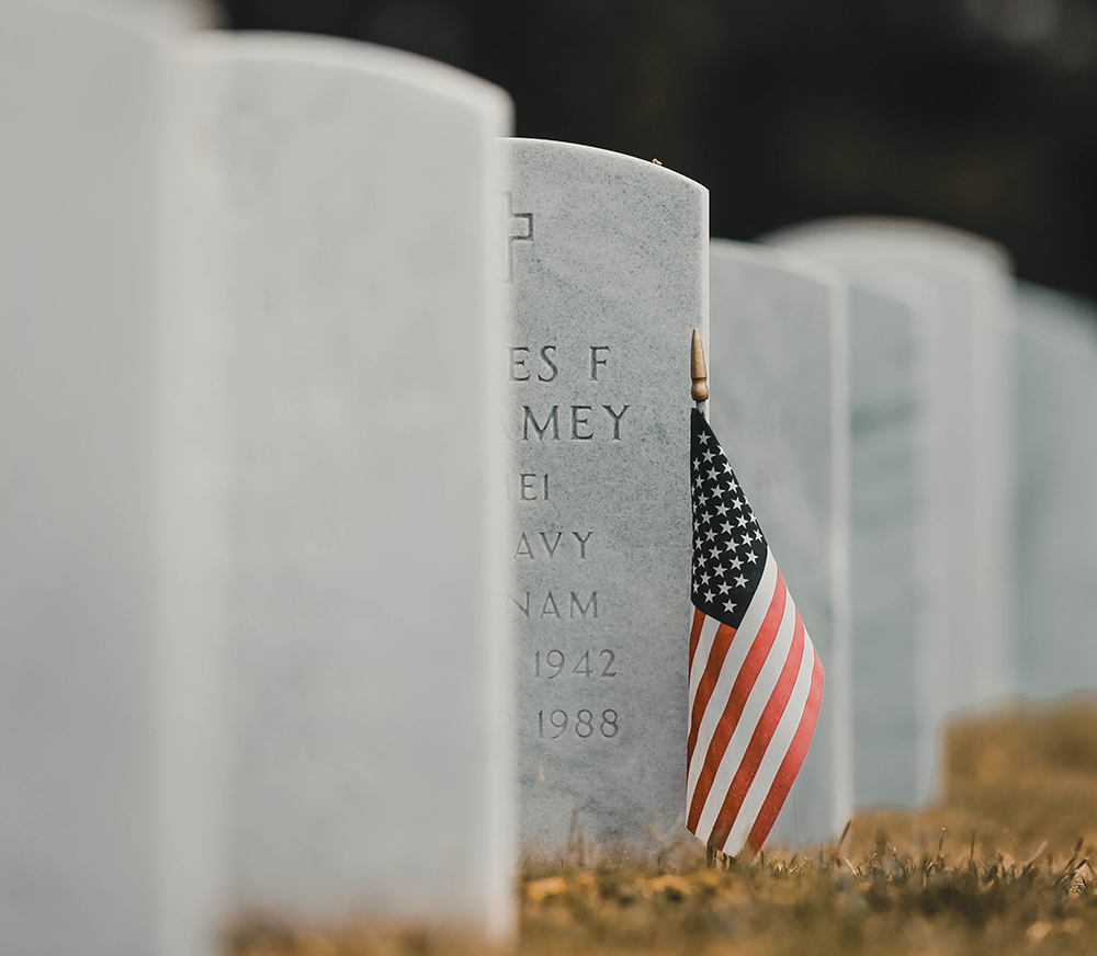 American flag next to gravestone